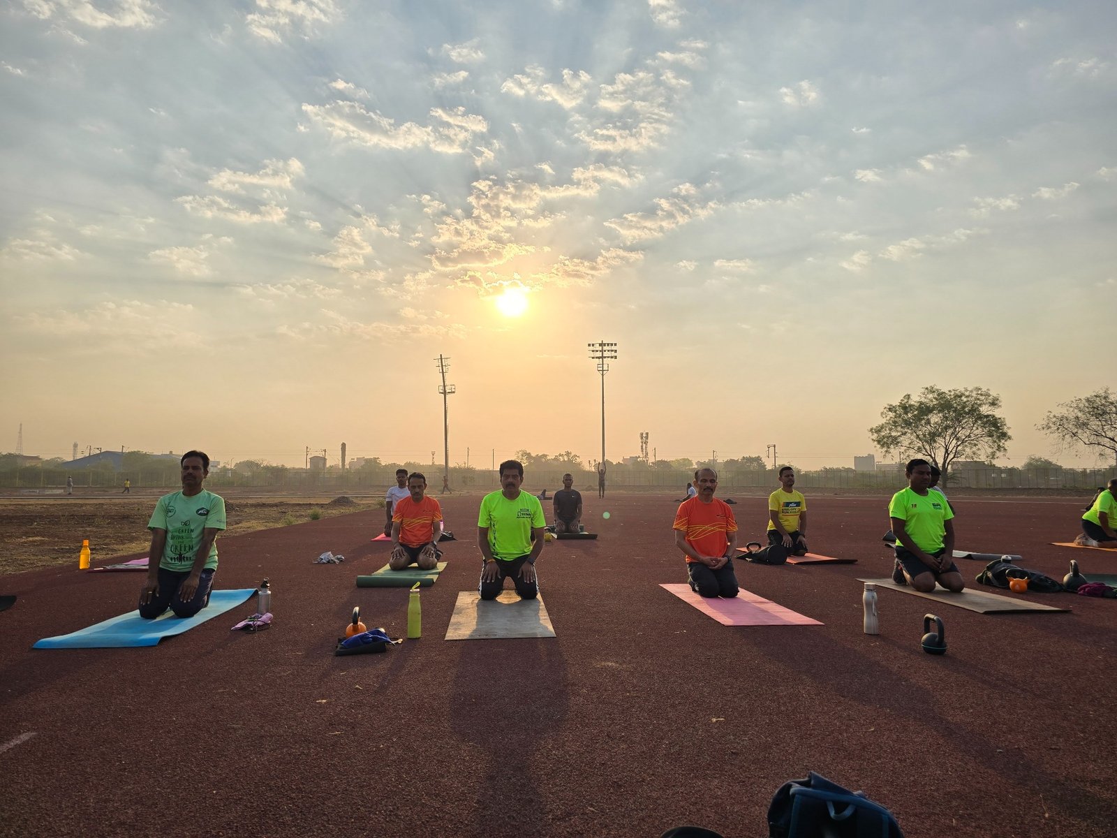 BCR members practising yoga at Ballari District Stadium at sunrise
